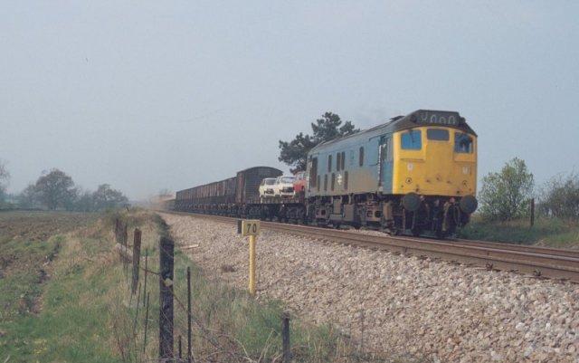 10/4/81:- 25056 heads a long mixed freight train westwards past Wadborough Crossing